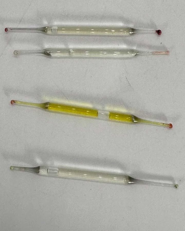 What are they? Found under a bathroom cabinet during renovations: small glass tubes, 5 cm long, filled with liquid. Any ideas?